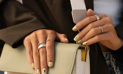 [freepicdownloader.com]-woman-showing-her-nail-art-fingernails-with-purse-medium